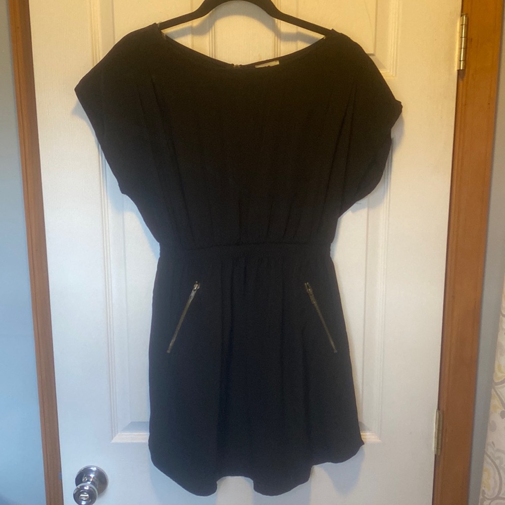 Black mini dress with brass zipper accents